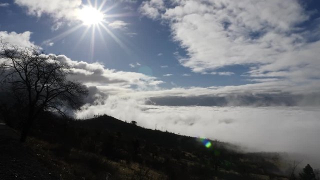 A look out over the Rogue Valley, from Roxy Ann Southern Oregon.  The sun shines brightly, but clouds begin to roll in.