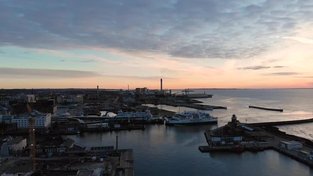 Aerial of ferry in central Helsingborg, Sweden coming into the harbor from Denmark and panorama over the city.