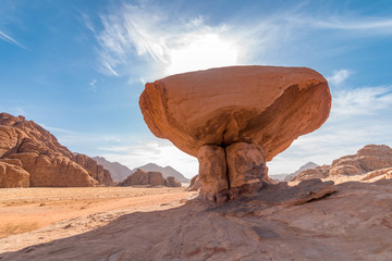 Mushroom rock formation against sun, Wadi Rum desert, Jordan