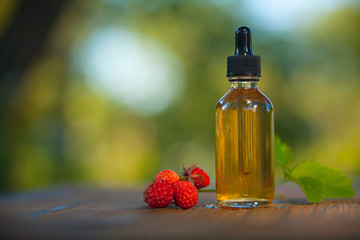 Essence of Wild strawberry on table in beautiful glass jar