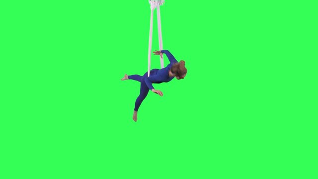 Acrobatic Tissue Artist performs wearing a blue suit over a green screen