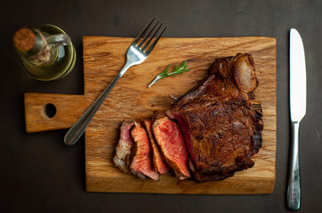 delicious steak, seasonings, a delicious piece of meat, cooked dinner on a concrete background