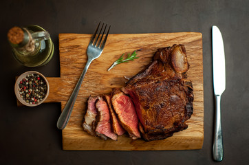 delicious steak, seasonings, a delicious piece of meat, cooked dinner on a concrete background