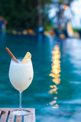 delicious pina colada cocktail by the luxury evening pool
