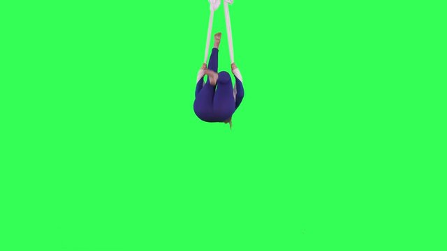 Acrobatic Tissue Artist performs wearing a blue suit over a green screen