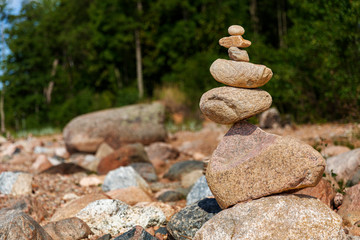 Fototapeta na wymiar Zen pyramid of stones on seashore.Concept harmony and balance,spa and yoga