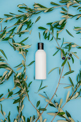 Cream in bottle with branches of olive
