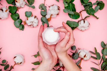 Cotton and Eucalyptus with health case cream in female hands