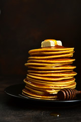Homemade pancakes with honey or maple syrup.