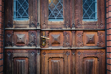 closeup of old wooden door with metal handle -