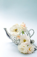 Decorative tea pot with white coral roses