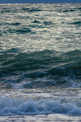 sea landscape is a pebbly beach with waves in white foam