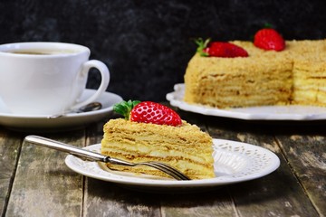 Slice of delicious cake with strawberry isolated on dark background. Copy space for your text
