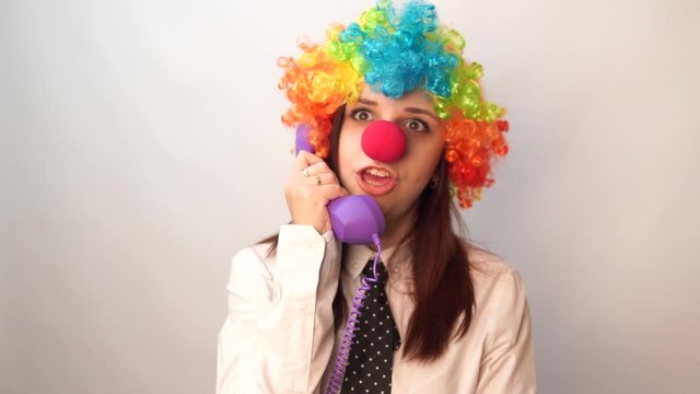 Office worker in clown wig, clown concept at work. Businessman with clown wig isolated on white. Girl Secretary in the form of a clown.