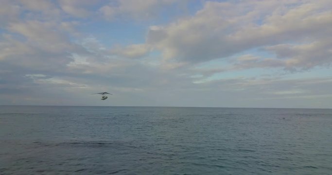 FIB - Flying Inflatable Boat. Aerial shot towards the amphibious aircraft performing in the sky above the sea.
