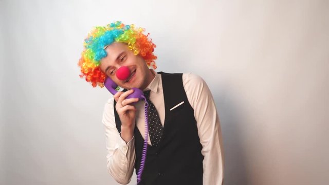 Office worker in clown wig, clown concept at work. Businessman with clown wig isolated on white