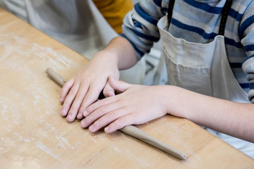 Children hands that mold from clay. Children creativity. Crafts from clay. Clay modeling courses. Clay modeling courses