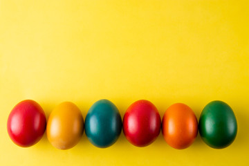 Colorful Easter eggs, easter or spring background with home painted eggs. Top view, copy space. Spring time. Colorful background.