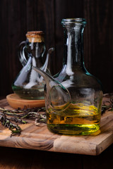 oil with Spanish olive oil of intense color and branches of rosemary on rustic wood