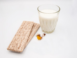 Glas of fresh sour milk with two whole wheat cracker breads