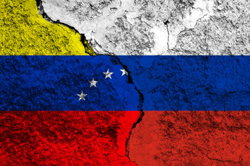 Flag of Venezuela and Russia on the background of the texture of frayed paint with a crack on the whole frame