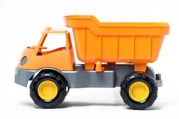 Fototapete Lastwagen  Plastic toy yellow truck on a white background. Close-up.  © shuravi07