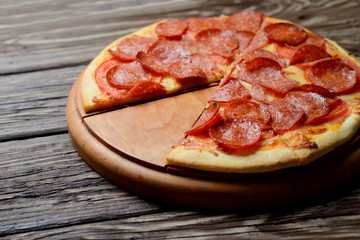 Pepperoni pizza on wooden table