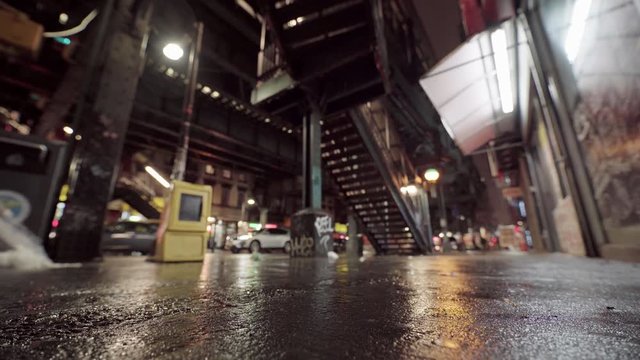 Out Of Focus Dystopian Street With Focus Rack on Asphalt and Tilt Down, Night