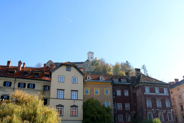 Fototapeta na wymiar Historical buildings in central Ljubljana, Slovenia. Ljubljana castle on the hill in the background.
