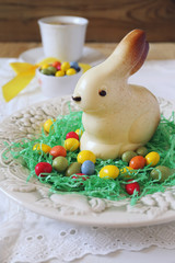 Easter tea with colorful candy and white chocolate bunny