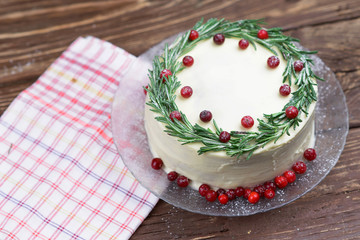  Cake with cream and decor of red berries and rosemary