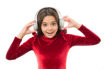 Enjoying his favorite music. happy childrens day. kid fashion and beauty. childhood and happiness. small girl in red dress. small child in headphones. music. listening ebook. audio education