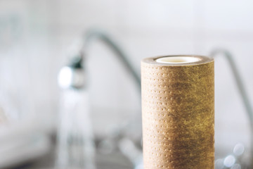 Dirty, brown, used water filter cartridges on background of the sink and tap with water, selective focus