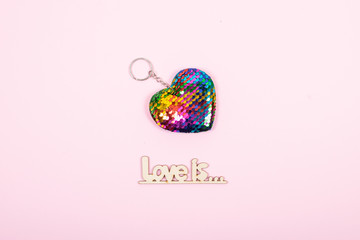 Valentines day pastel minimal creative background. Text Love is and rainbow Lgbt gay heart on pink background. Valentines day, Love, romance, homosexual concept