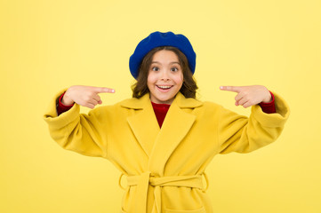 Place for ad advertisement. Child promoting something yellow background. Girl pointing index fingers herself. Advertising product. Look at this. Advertisement launching product. Advertisement concept