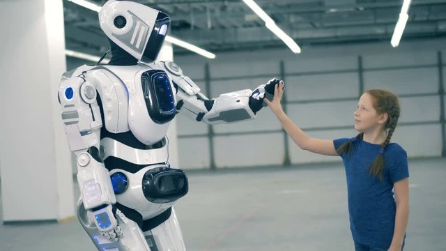Cybrog is giving a high-five to a little girl