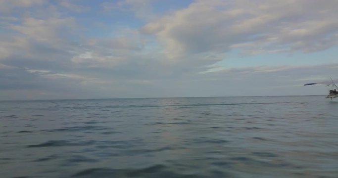 FIB - Flying Inflatable Boat. Aerial shot tracking the amphibious aircraft flying above the sea level.