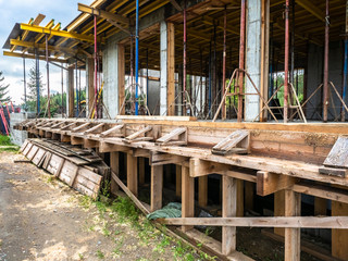 Home construction. Cottage frame. Construction works. Concrete frame houses. Pouring concrete. Materials for the construction of the building. Scaffolding. Formwork
