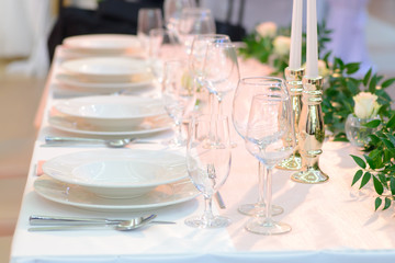 Wedding table place setting, plates and glasses