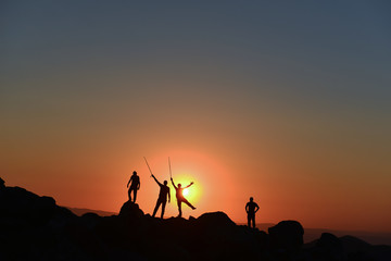 team of four people climbers and peak success in sunrise time