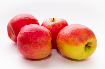Fototapeta na wymiar four red-yellow apples on a white background