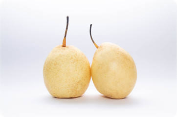two yellow pears on a light blue and white background
