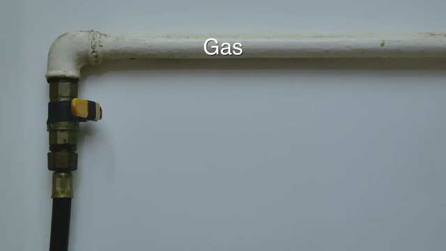 close-up of mans hand close and open gas pipe valve at home. close-up video footage with white background