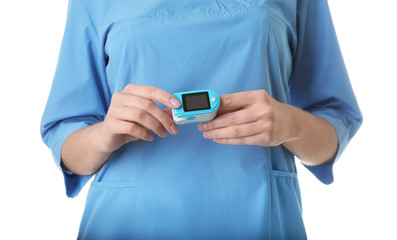 Female doctor using heart rate monitor on white background, closeup. Medical object