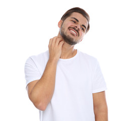 Young man scratching neck on white background. Annoying itch