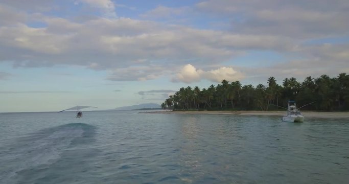 FIB - Flying Inflatable Boat. Aerial shot following the amphibious aircraft taking off and flying above the sea.