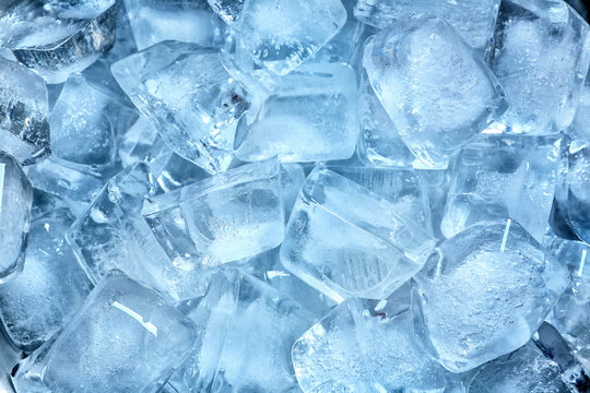 Many ice cubes on color background, top view