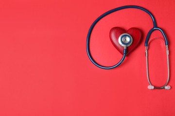 Stethoscope and red heart with space for text on color background, flat lay