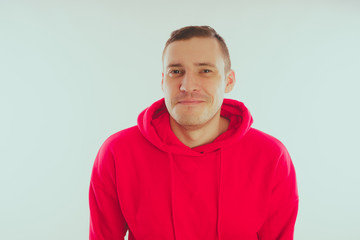 Crazy and charismatic guy posing. A man in a red tracksuit. Man isolated on white background, space for text