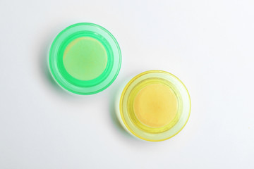 Bright magnets on white background, top view